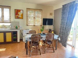 a kitchen with a table and chairs in a room at Seahorse Appartments in Grand Baie +15 photos