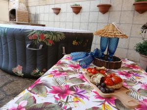 a table with a table cloth with food on it at Casa Briseida in Baia Verde