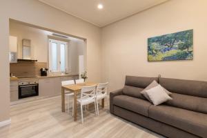 a living room with a couch and a table at Bianca - Roby - Paolo Apartments by Mamo Florence in Florence