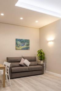 a living room with a couch and a painting at Bianca - Roby - Paolo Apartments by Mamo Florence in Florence