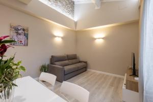 a living room with a couch and a table at Bianca - Roby - Paolo Apartments by Mamo Florence in Florence +52 photos