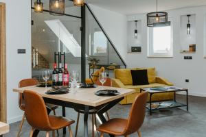 a dining room with a table with wine bottles and chairs at Ady54 in Tata