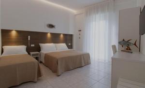 Postel nebo postele na pokoji v ubytování Hotel Napoleon