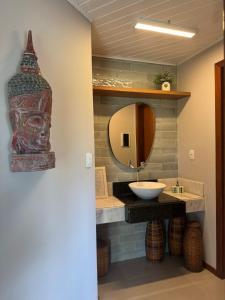 a bathroom with a sink and a mirror at Aytyaram Praia Suítes - Aytyaram Exclusive in Barra Grande