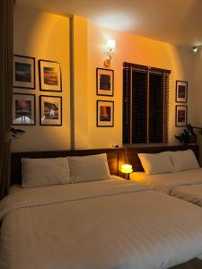 a bedroom with two beds and a window at Villa Délight House “Stay&Chill” in Da Lat