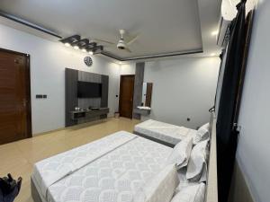 Postel nebo postele na pokoji v ubytování Holiday One Hotel & Suites
