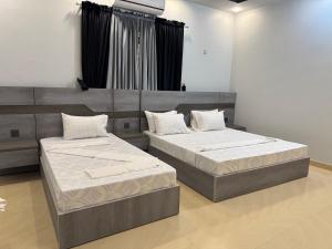 Postel nebo postele na pokoji v ubytování Holiday One Hotel & Suites