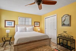 Un dormitorio con una cama y un ventilador de techo. en Blues Beach Bungalow, en Navarre