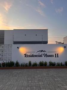 a building with a sign for residentialumes ii at Casa 100% mobiliada no Caçari in Boa Vista +5 photos