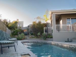 a swimming pool in front of a house at Mountain View Guesthouse in Springbok