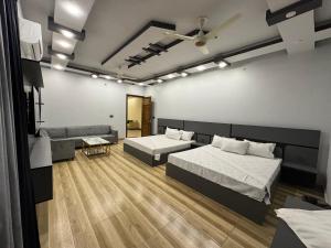 Postel nebo postele na pokoji v ubytování Holiday One Hotel & Suites