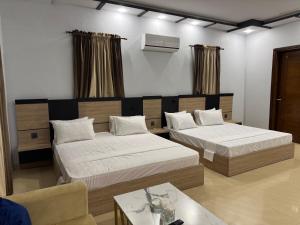 Postel nebo postele na pokoji v ubytování Holiday One Hotel & Suites