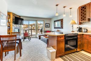 a kitchen and living room with a stove top oven at Dillon Reservoir On-Site Central and Scenic Condo! in Dillon