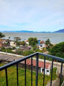 a view of the ocean from a balcony at Apartamento Refúgio das Ondas com Piscina in Enseada do Brito