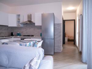a kitchen with a stainless steel refrigerator and a table at Vista Capo d'Orlando in Capo dʼOrlando
