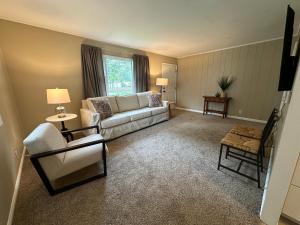 a living room with a couch and a chair at Cute & Cozy 2 Bedroom Near Park in Midland