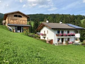 a house on a hill with a green field at Brixlechnerhof in Maranza