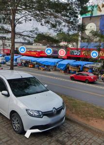 a white car parked on the side of a street at Hostel Thiago in Santa Cruz