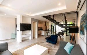 a living room with a couch and a table at Villa Roma in Akumal