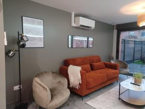 a living room with a couch and a chair at Appartement jardin bailleul 02 in Bailleul