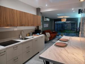a kitchen with a counter top and a living room at Appartement jardin bailleul 02 in Bailleul