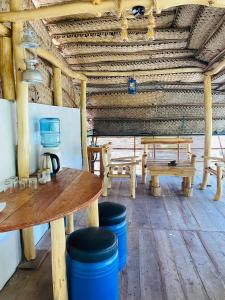 a room with wooden tables and benches in a building at Airport Accommodation in Maduwa +17 photos