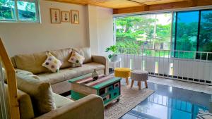 a living room with a couch and a table at Pine Beach House Alleppey in Alleppey