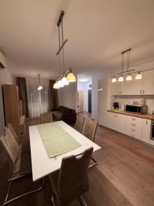 a kitchen and a living room with a table and chairs at Mirvana Apartments Solis Grande in Timişoara