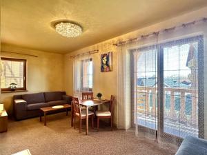 a living room with a couch and a table at Holiday Resort Tatry in Veľká Lomnica