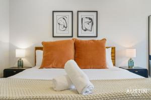 a bedroom with a white bed with two lamps at Brand New Studio Apt w King Bed Kitchenette in Steiner Ranch by Austin Vacay in Austin