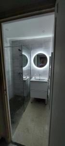 a bathroom with a shower and a sink and a mirror at Maison Cosy à Rieux-Minervois in Rieux-Minervois