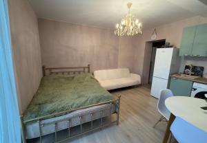 a small bedroom with a bed and a kitchen at თბილისი in Bakuriani