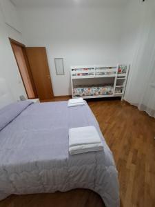 a bedroom with a large bed with two towels on it at Casa Mare Roma in Lido di Ostia