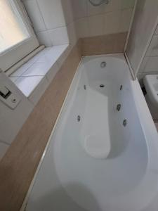 a small bathroom with a tub and a toilet at Casa Mare Roma in Lido di Ostia +29 photos