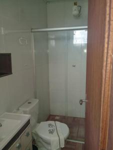 a bathroom with a toilet and a glass shower at Apartamento e suítes Itacaré in Itacaré +30 photos