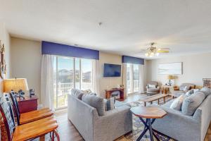 a living room with two couches and a table at Dolphin's Run 204 DSS in Virginia Beach