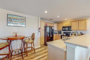 a kitchen with a table and a counter top at Dolphin's Run 204 DSS in Virginia Beach