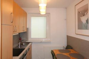 a small kitchen with a table and a window at 502 Comfort Housing in Falkensee