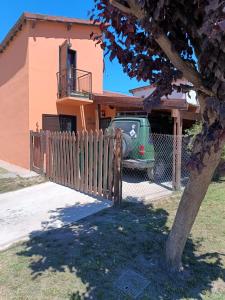 a green truck parked in front of a house at Alquilo casa dúplex!!! in Necochea