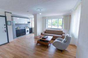 a living room with a couch and a table at Lina Apart in Arnavutköy