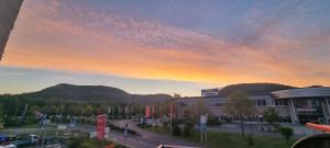 a view of a building with a sunset in the sky at Burgau Apartments Modern & Renovated in Jena