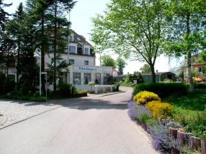 a street in front of a building with flowers at Villa Seeperle - Sturmvogel in Dahme