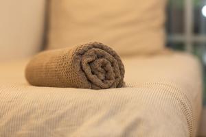 a towel on the edge of a bed at Domaine Bordaberry T2 Jardin et Superbe piscine in Urrugne
