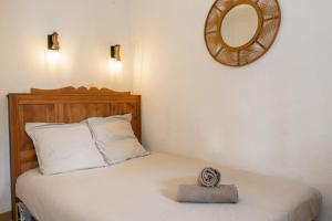 a bedroom with a bed with a mirror on the wall at Domaine Bordaberry T2 Jardin et Superbe piscine in Urrugne +41 photos