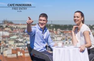 a man and a woman sitting at a table with champagne glasses at Wenceslas Square Hotel - Czech Leading Hotels in Prague