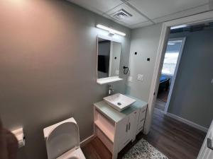 a bathroom with a sink and a toilet and a mirror at Almira Properties Apartments in Providence +49 photos