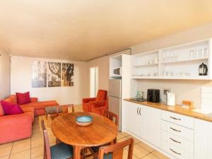a kitchen and living room with a table and a couch at Mountain View Guesthouse in Springbok