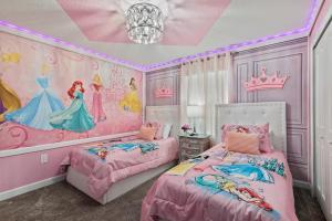 a disney princess bedroom with two beds and a chandelier at Lakeview 5BR with Game Room and Pool, Near Disney in Kissimmee +31 photos