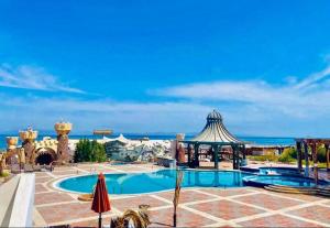 a resort with a pool and a gazebo at GULF Playa luxury in Dahab