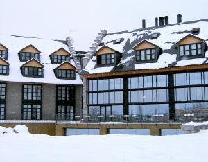 a building covered in snow at Apartamentos HG Cerler in Cerler
